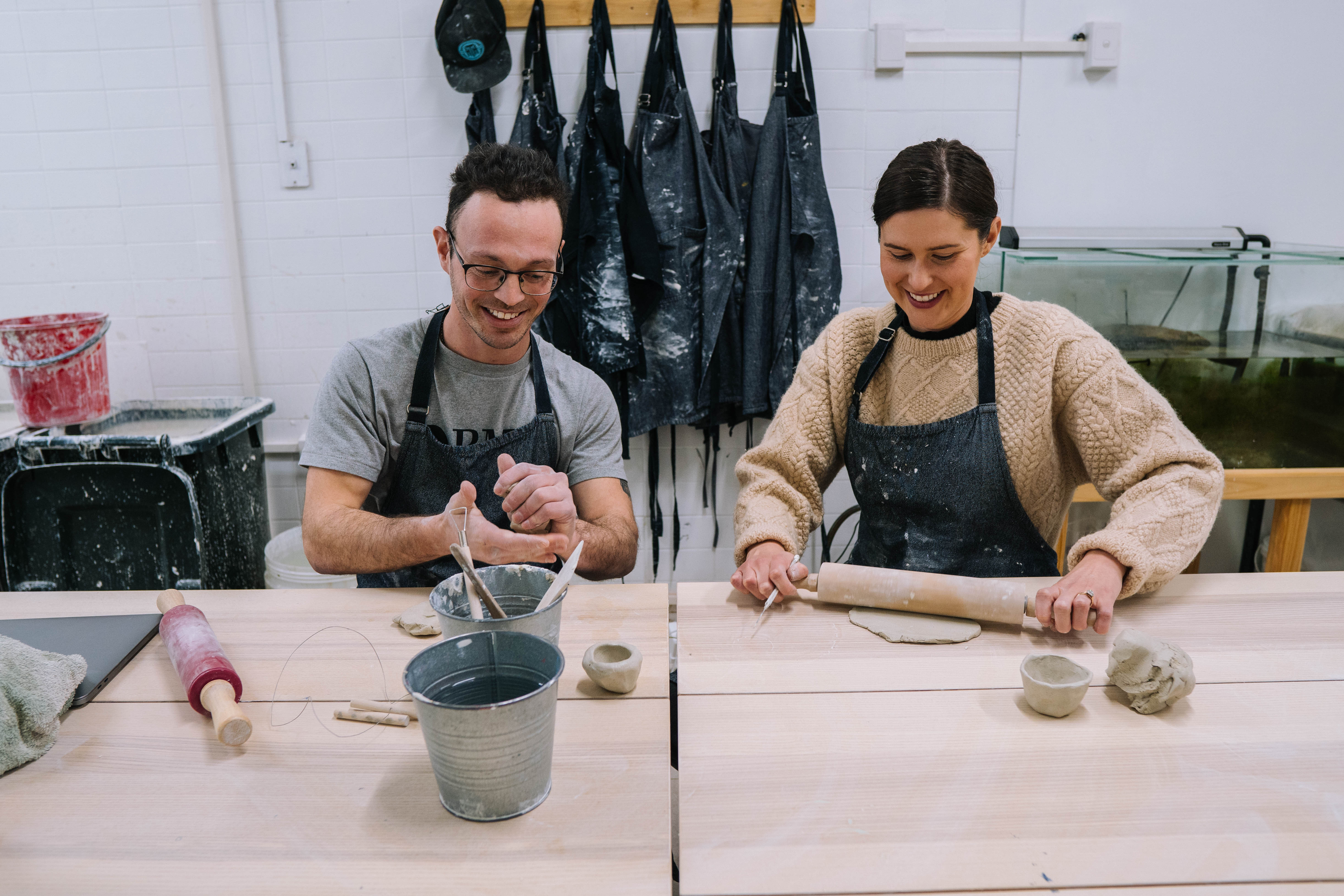 A couple enjoy a hand building pottery class together